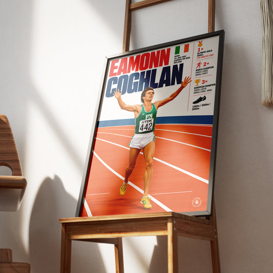 A framed poster of sprinter Eamonn Coghlan displayed on a wooden easel in a modern interior setting with warm natural light casting shadows on the wall.