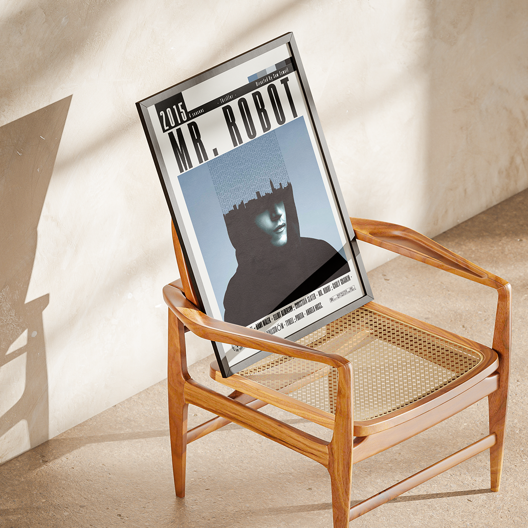 A framed art print titled 'MR. ROBOT' leaning against a wooden armchair in a sunlit room with a textured beige wall and floor.