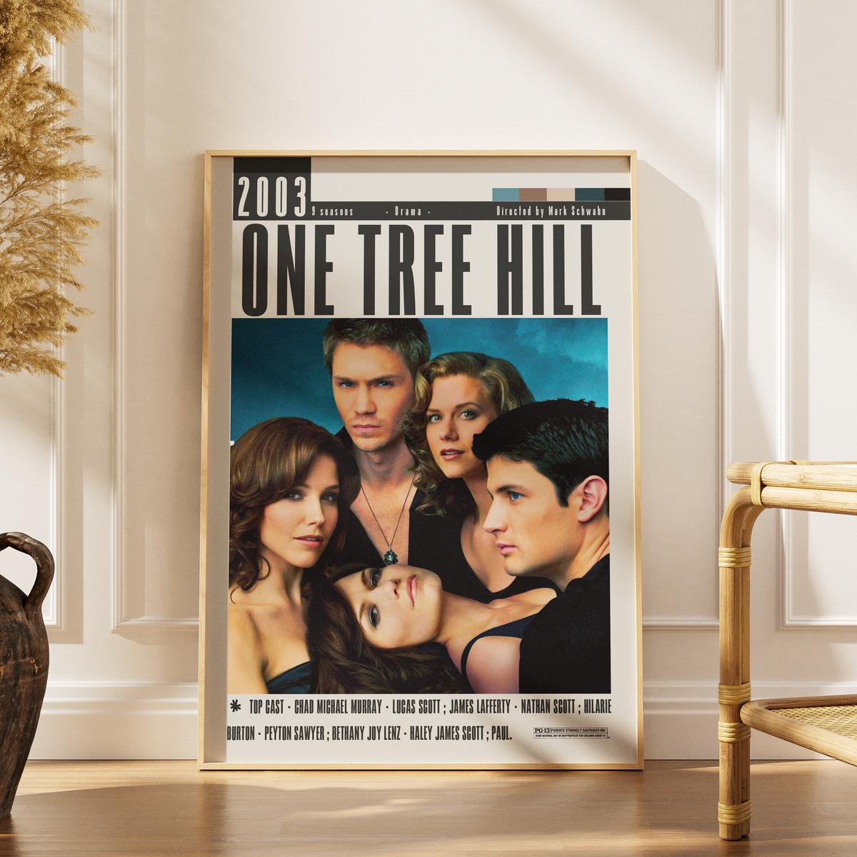 Framed 'One Tree Hill' poster on a wall with decorative elements.