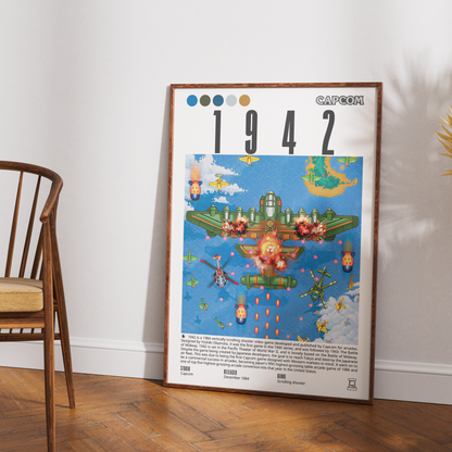 A framed Capcom 1942 poster leaning against a white wall on a wooden floor, next to a wooden chair.