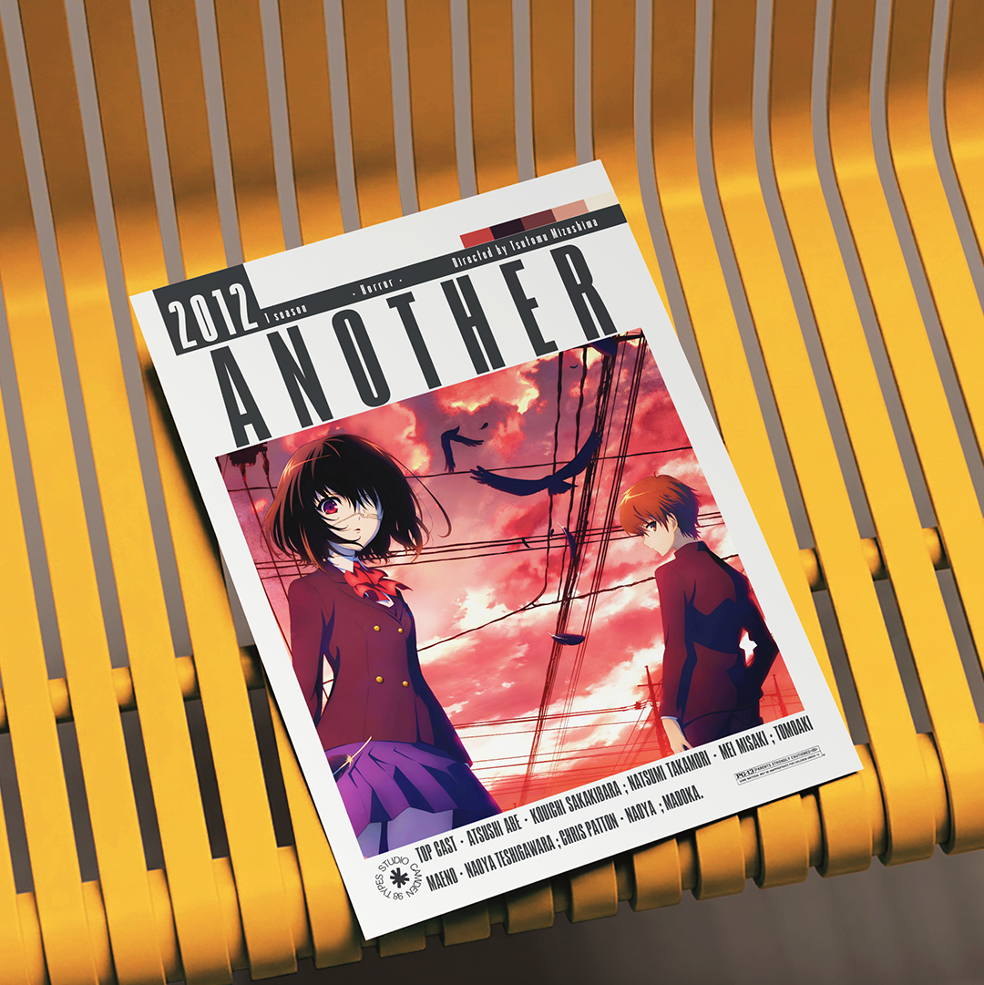 A magazine or book cover titled "ANOTHER 2012" lies on a yellow slatted chair. The cover features anime-style artwork with two characters against a pink and orange sky, with the text "Written and Directed by Toshiyuki Morikawa" visible.