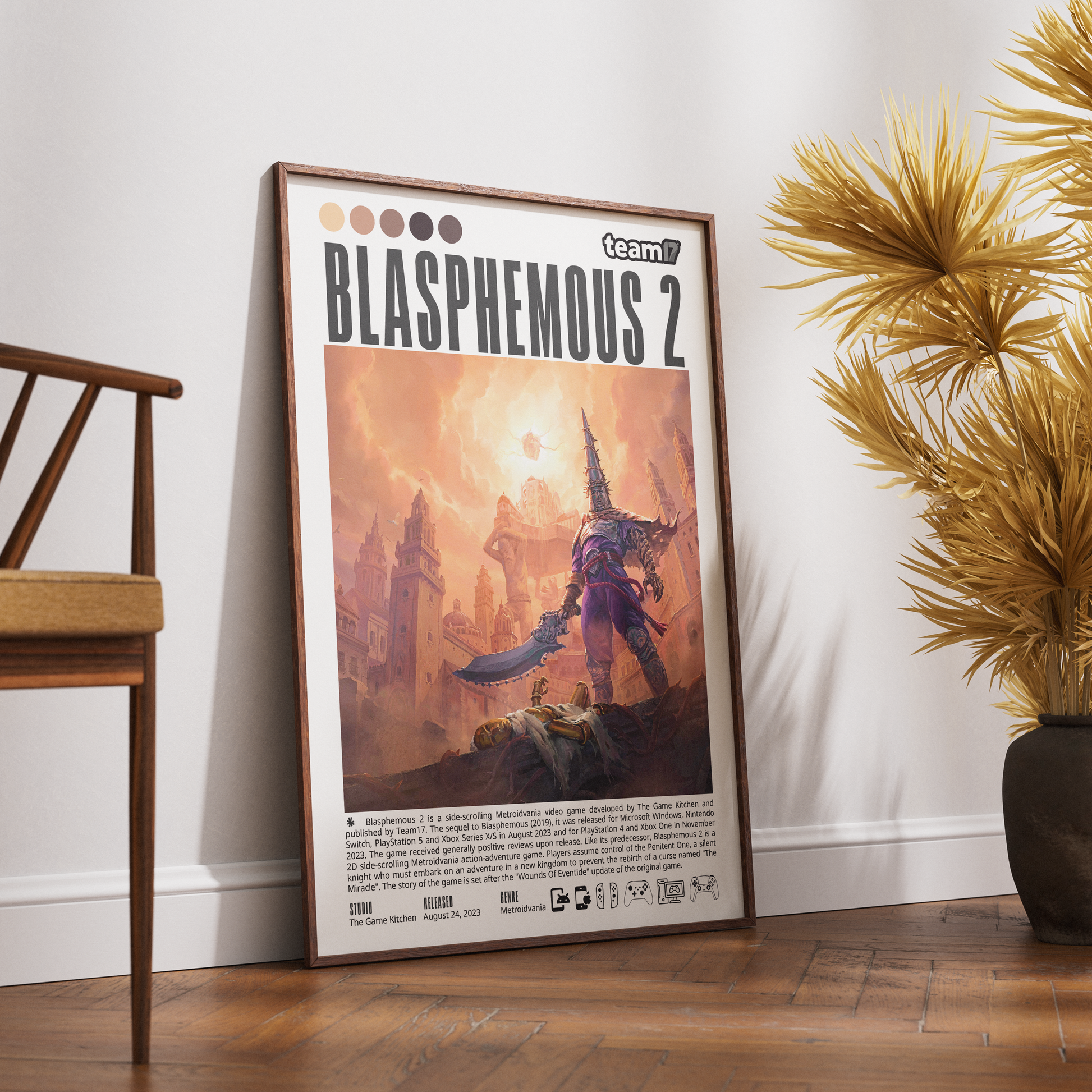 A framed poster of the video game Blasphemic 2 leaning against a white wall on a wooden floor, next to a wooden chair and a potted plant.