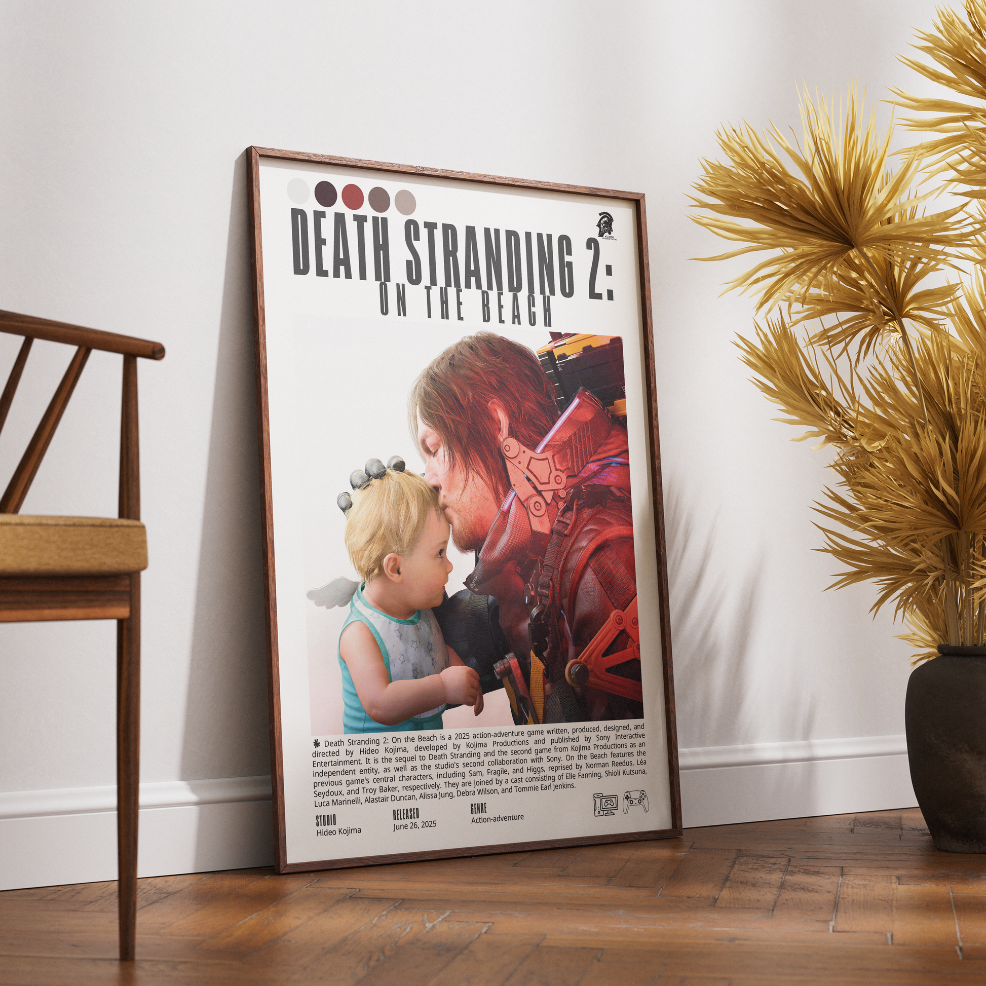 A framed movie poster for 'Death Stranding 2: On the Beach' leaning against a white wall on a wooden floor, next to a wooden chair and a potted palm.