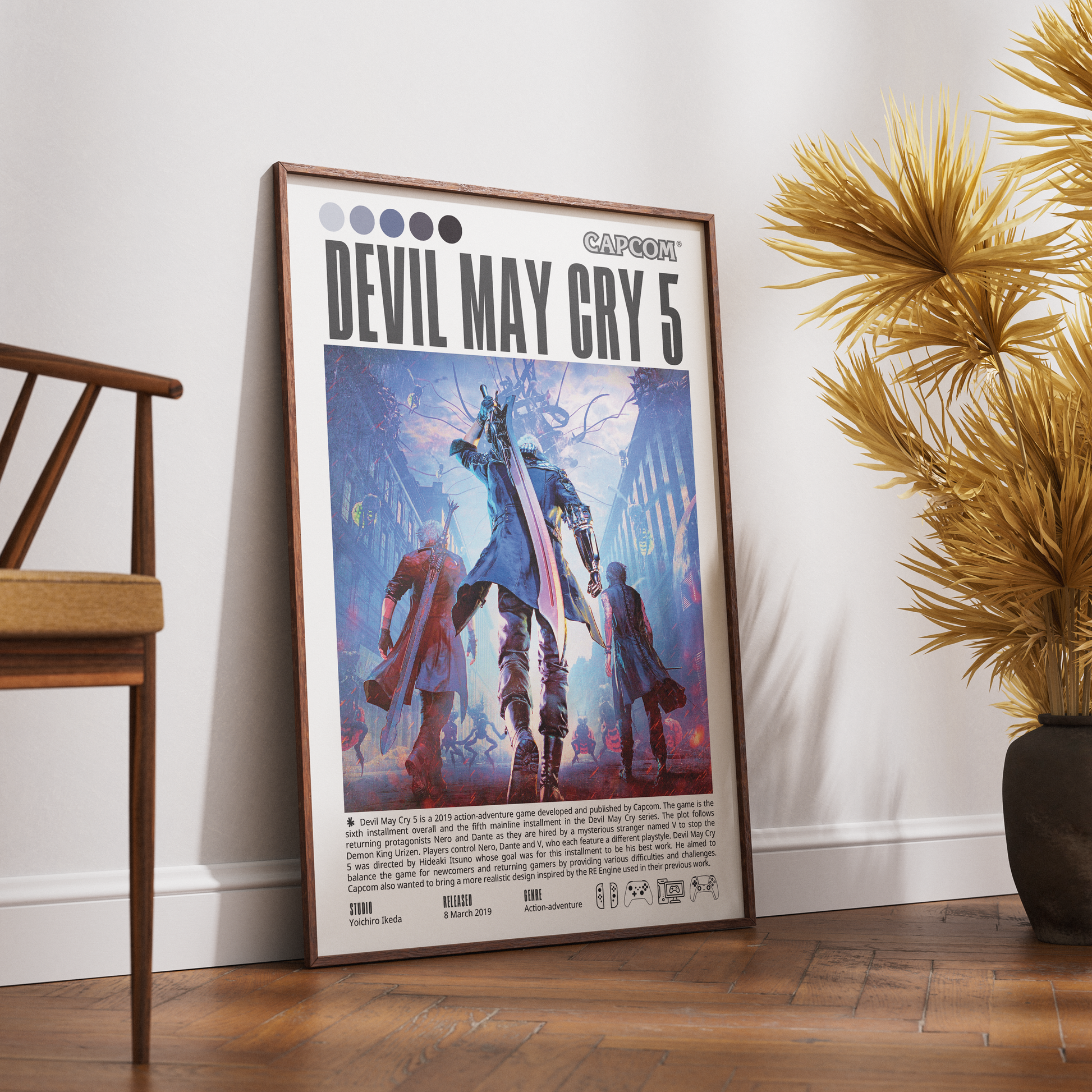 A framed 'Devil May Cry 5' poster leaning against a white wall on a wooden floor, styled in a room with a wooden chair on the left and a potted plant on the right.