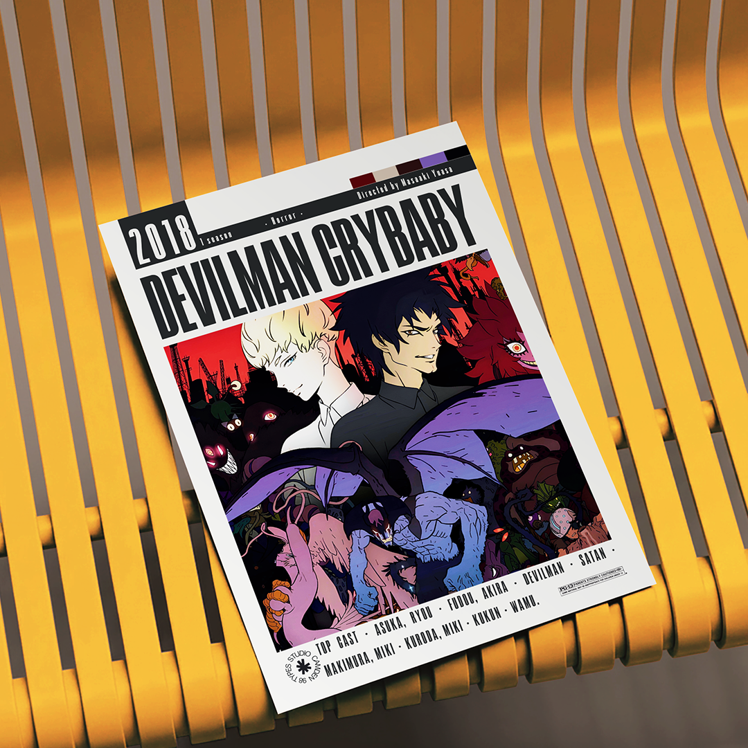 A comic book titled 'Devilman Crybaby 2018 Edition' displayed on a yellow slatted bench. The cover features anime-style artwork with characters in black, red, purple, and blue tones.