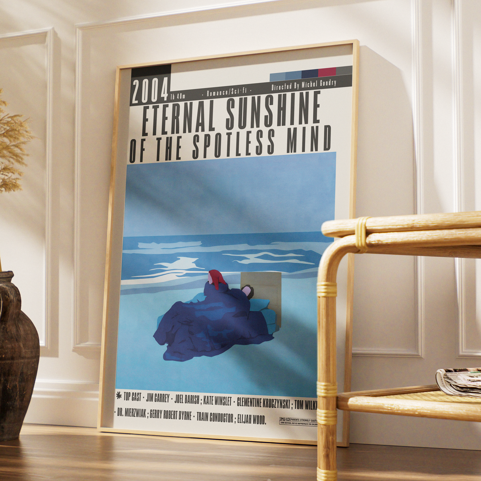 Framed movie poster for 'Eternal Sunshine of the Spotless Mind' in a room with a chair and decorative elements.