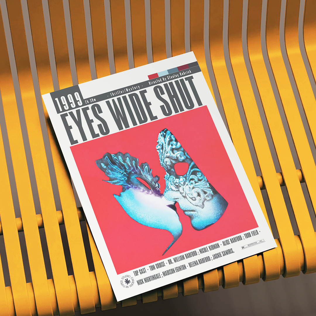A magazine or book cover titled "EYES WIDE SHUT" lies on a yellow slatted bench. The cover features a bold red background with a stylized blue and white face illustration and black text.
