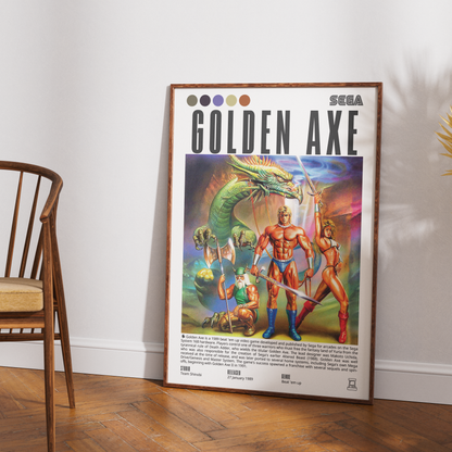 A framed vintage-style 'Golden Axe' Sega poster leaning against a white wall on a wood floor, with part of a wooden chair visible on the left.
