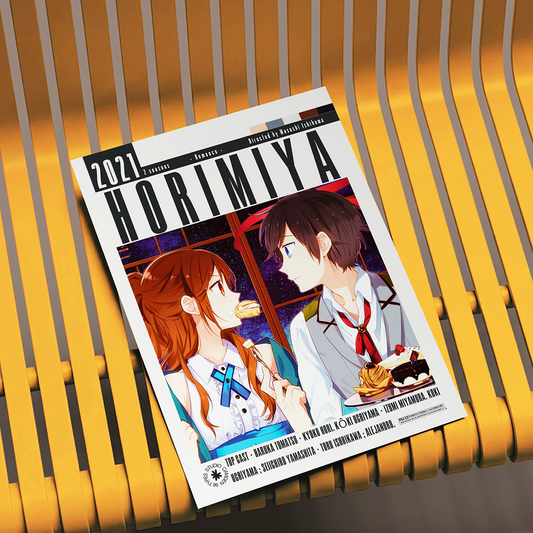 A magazine or book titled 'HORIMIYA 2021' with anime-style cover art, placed on a yellow slatted chair.