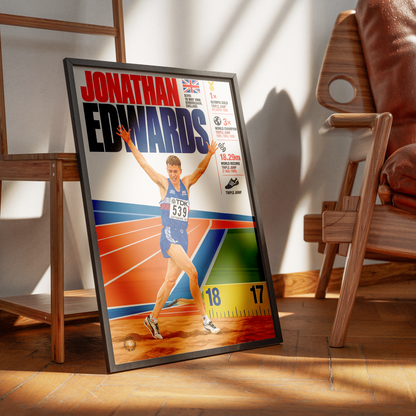 A framed sports poster of athlete Jonathan Edwards leaning against a wall in a modern wooden room setting.