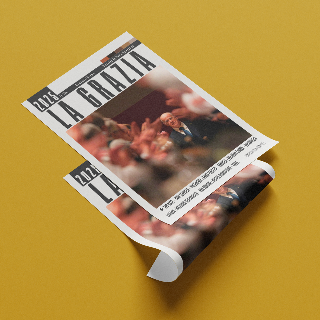 A rolled newspaper or magazine titled "LA GRAZIA" with the date "24.2.