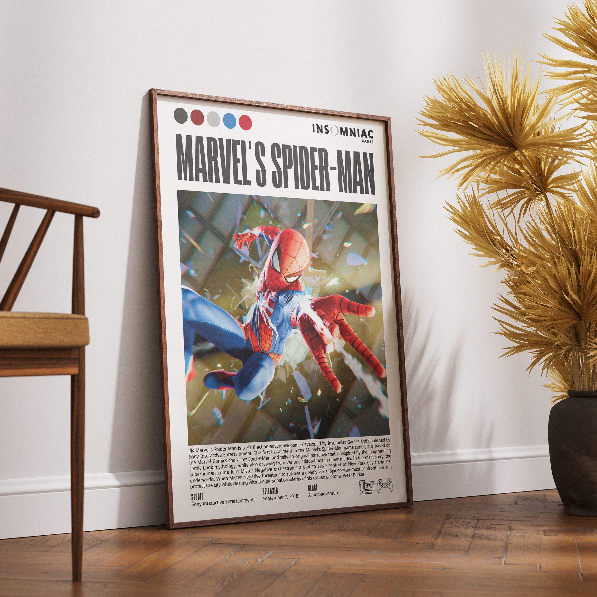 A framed Marvel Spider-Man poster leaning against a white wall on a wooden floor, with a wooden chair on the left and a potted plant on the right.