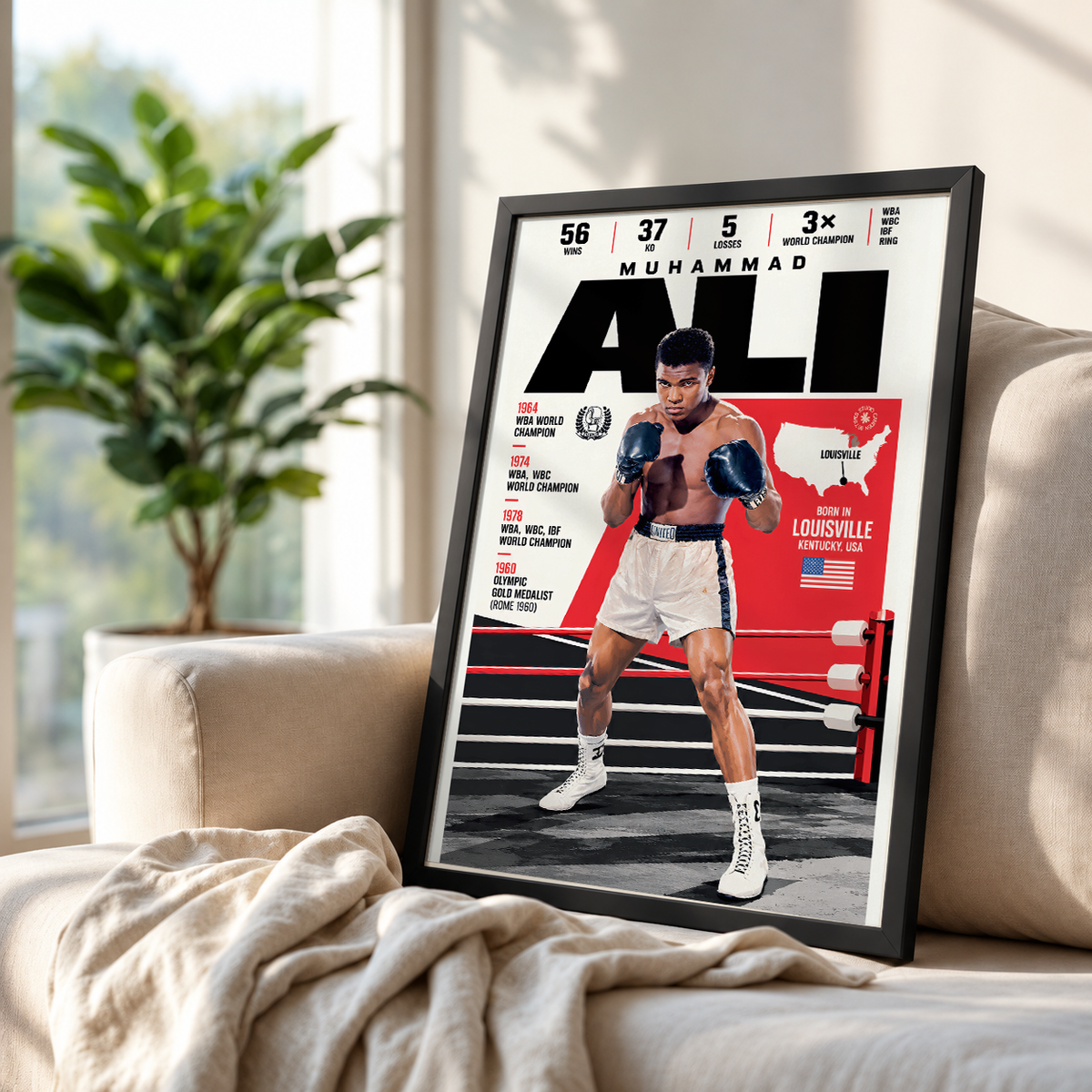 A framed poster of Muhammad Ali styled on a beige sofa in a bright living room setting.