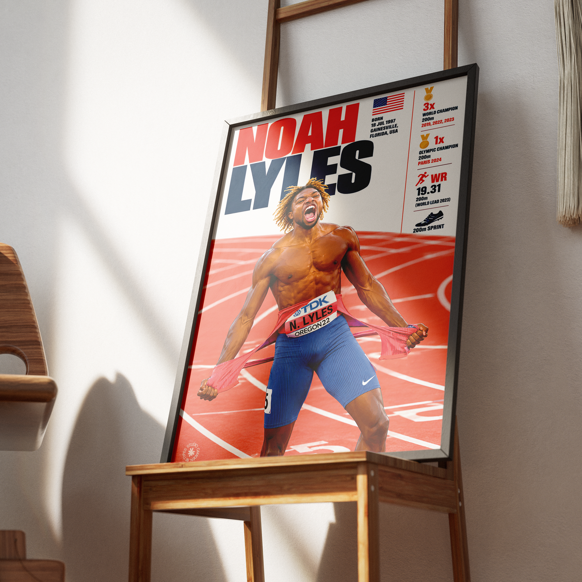 A framed sports poster of track athlete Noah Lyles leaning against a wooden table in a modern interior setting.
