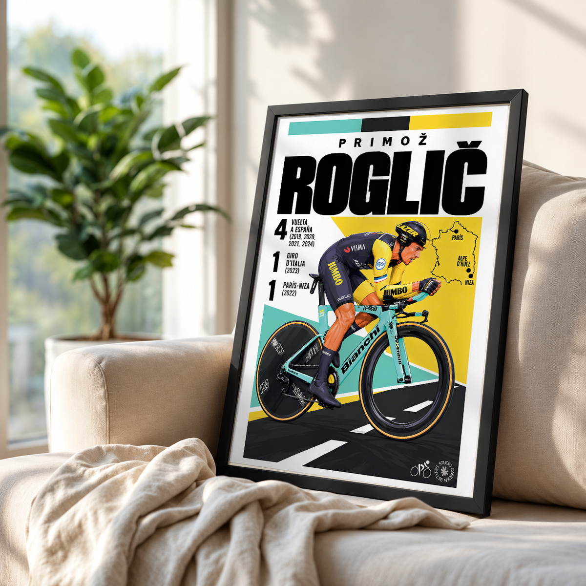 A framed cycling poster featuring Primož Roglič leaning against a beige sofa in a bright living room with a plant in the background.