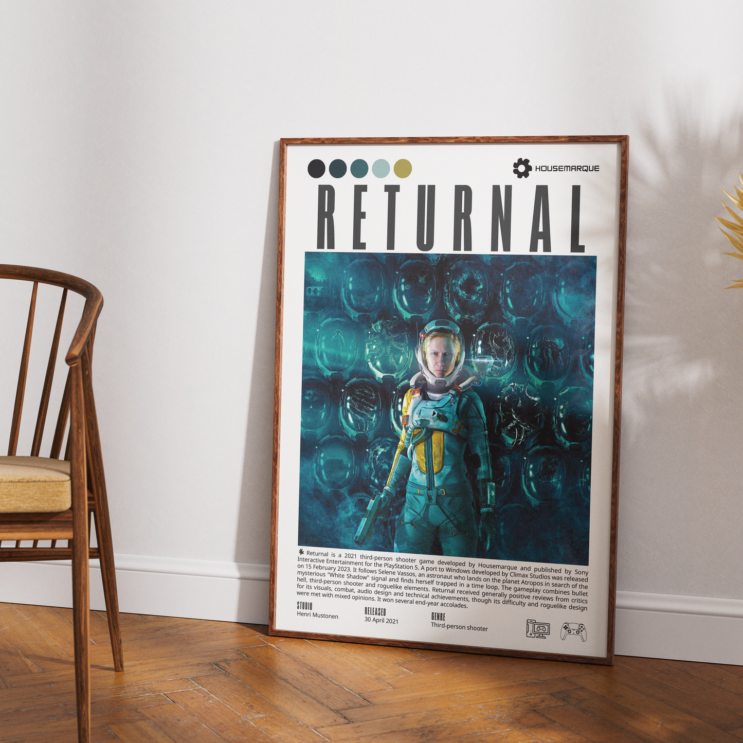 A framed poster titled 'RETURNAL' leaning against a white wall on a wooden floor, next to a wooden chair. The poster features a dark teal and black graphic illustration of an astronaut in a spacesuit.