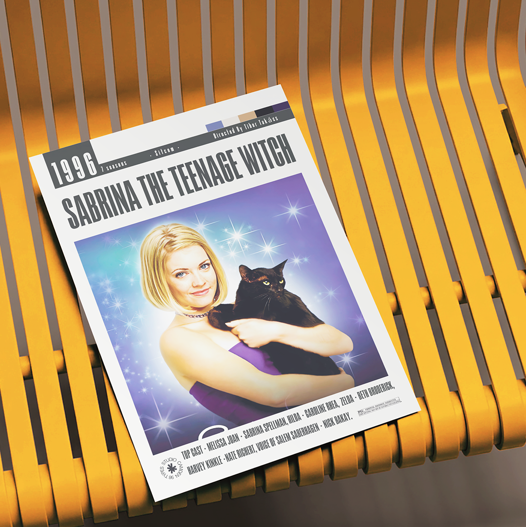 A magazine or book cover titled "1996 Sabrina the Teenage Witch" lies on a yellow slatted chair. The cover features a blonde woman holding a black cat against a purple starry background.