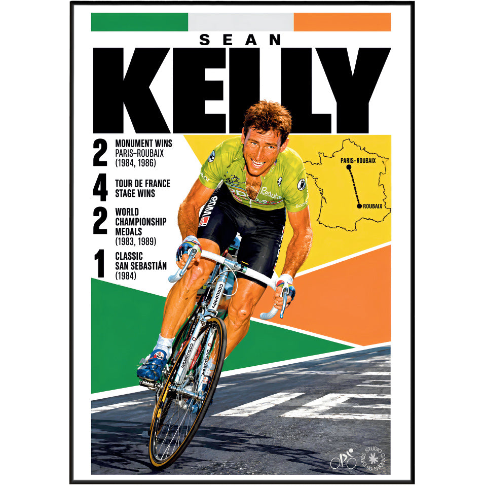 A framed cycling poster featuring Sean Kelly in a green jersey riding a road bike, with large black 'SEAN KELLY' text, race statistics, a small map of Vichy, and a multicolor geometric background.