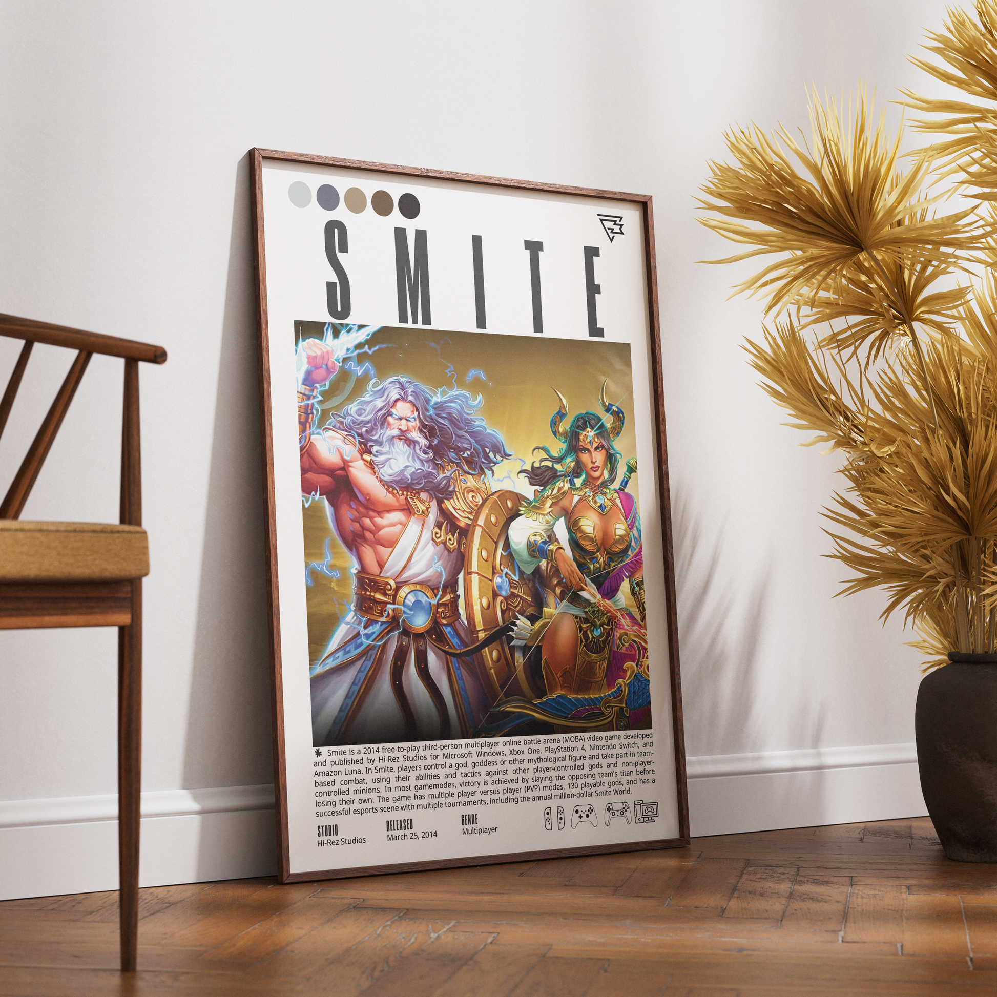 A framed art print featuring the 'SMITE' video game cover art, styled leaning against a white wall on a wooden floor next to a wooden chair and a potted plant.