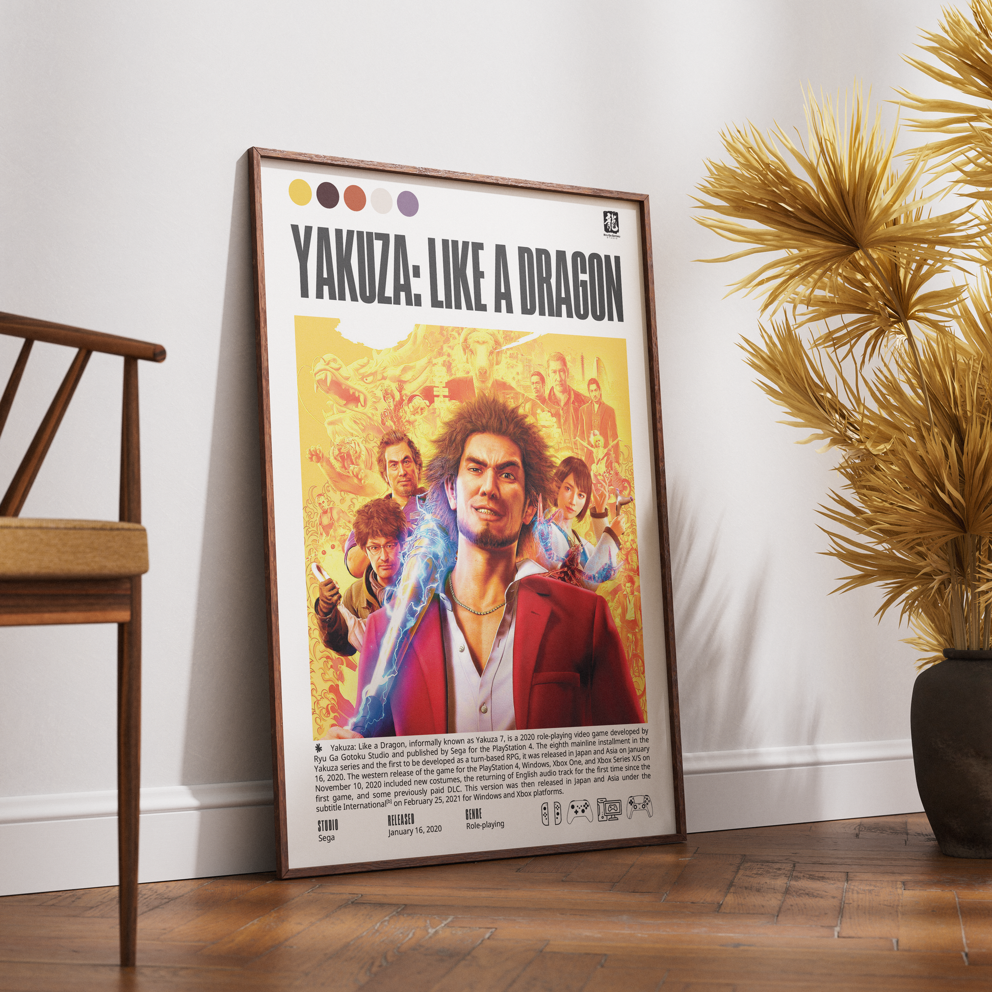 A framed poster of the movie 'Yakuza: Like a Dragon' leaning against a white wall on a wooden floor, styled in a room with a wooden chair on the left and a potted plant on the right.