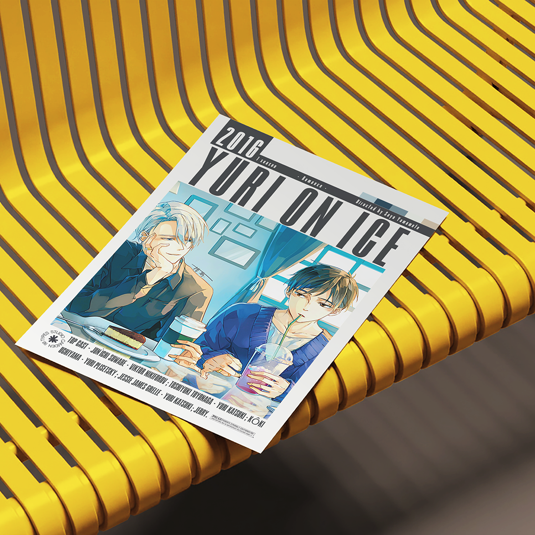 A printed magazine or comic cover titled "2016 YURI ON ICE" lies diagonally on a bright yellow ribbed bench. The cover features illustrated anime-style male characters seated at a table with drinks.