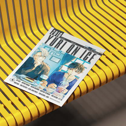 A printed magazine or comic cover titled "2016 YURI ON ICE" lies diagonally on a bright yellow ribbed bench. The cover features illustrated anime-style male characters seated at a table with drinks.