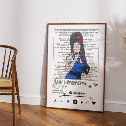 A framed art print featuring a stylized illustration of a woman with a red bow and blue dress over song lyrics, leaning against a white wall on a wooden floor next to a wooden chair.