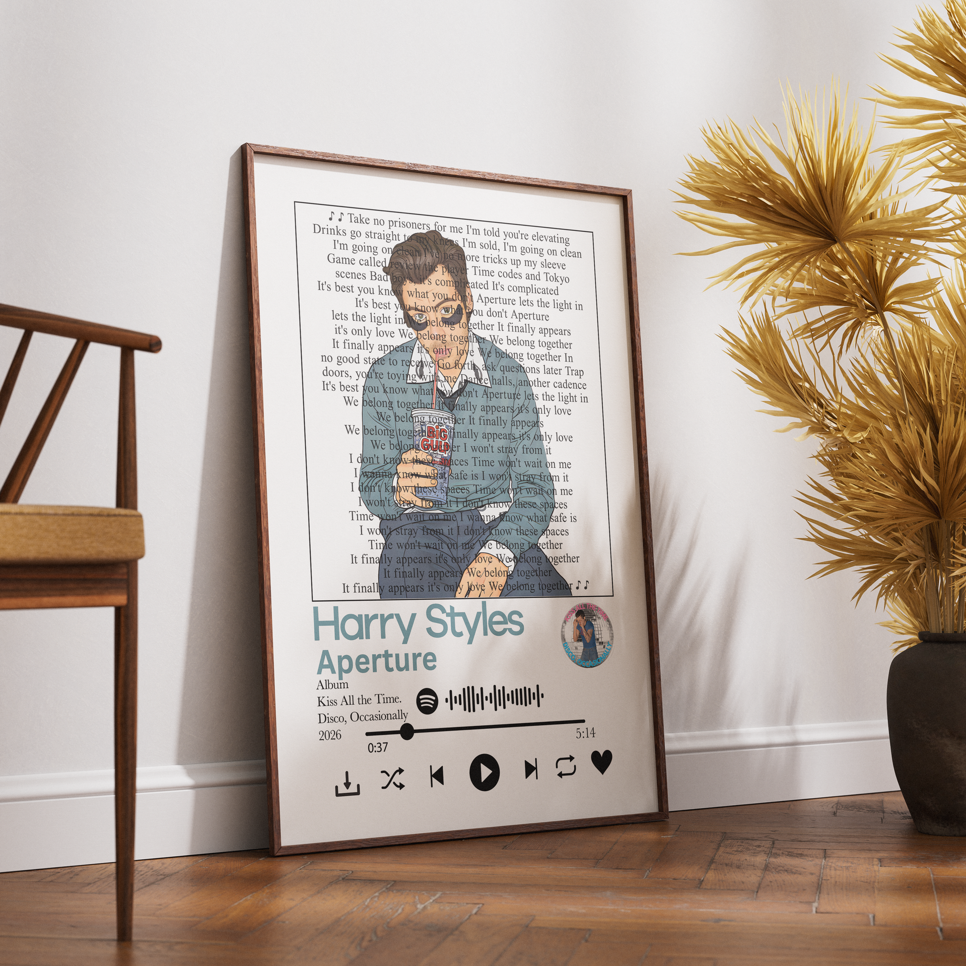A framed personalized music poster leaning against a white wall on a wooden floor, styled in a room with a chair and a potted plant. The poster features a custom illustration of Harry Potter holding a phone, with song lyrics printed in the background and the title 'Harry Styles Aperture' at the bottom.
