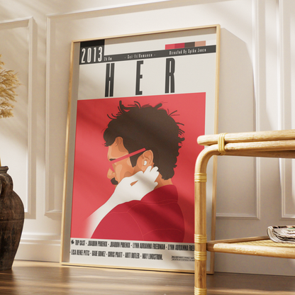 A framed art print featuring a stylized illustration of a woman in a red top and white gloves, leaning against a white paneled wall in a styled interior setting.
