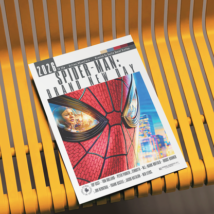 A printed Spider-Man: Brand New Day comic/booklet cover lies on a yellow slatted bench. The cover features a large close-up of Spider-Man's red mask with a city skyline and a woman visible in the eye area.
